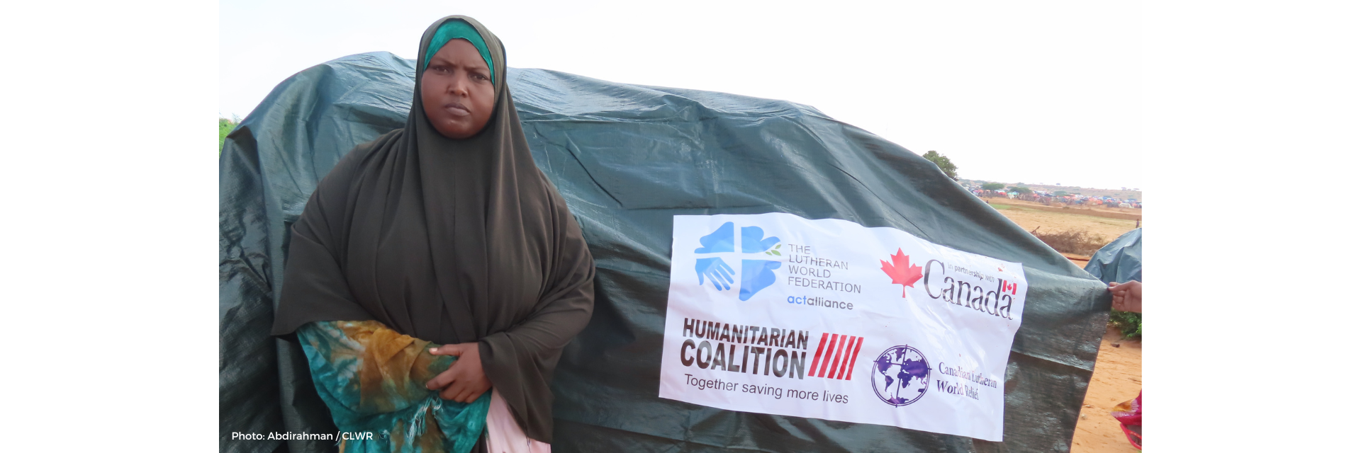 Hadija in front of her new shelter