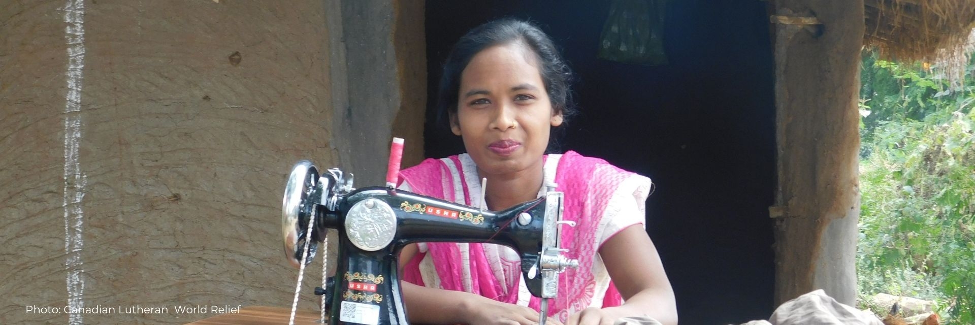 Santoshi sits at her new sewing machine