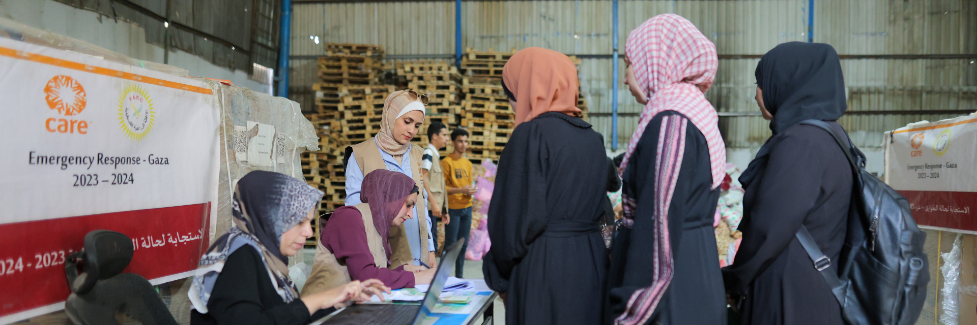 Three women line up to register for aid in Gaza