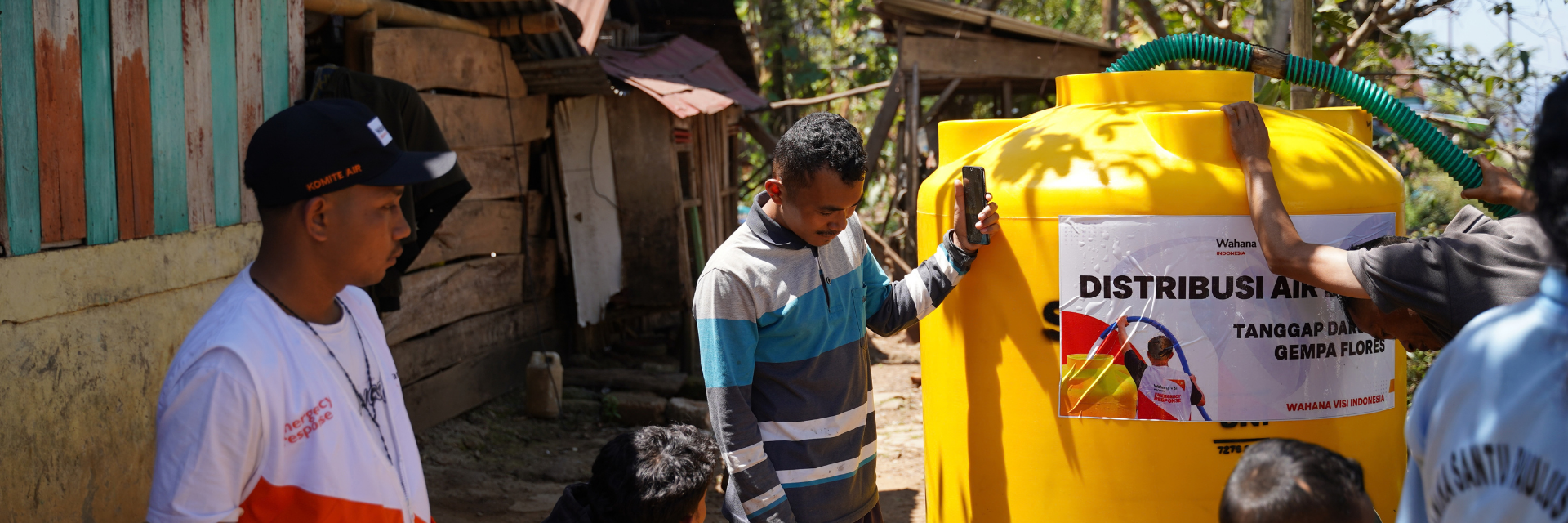 Humanitarian workers installing a water tank