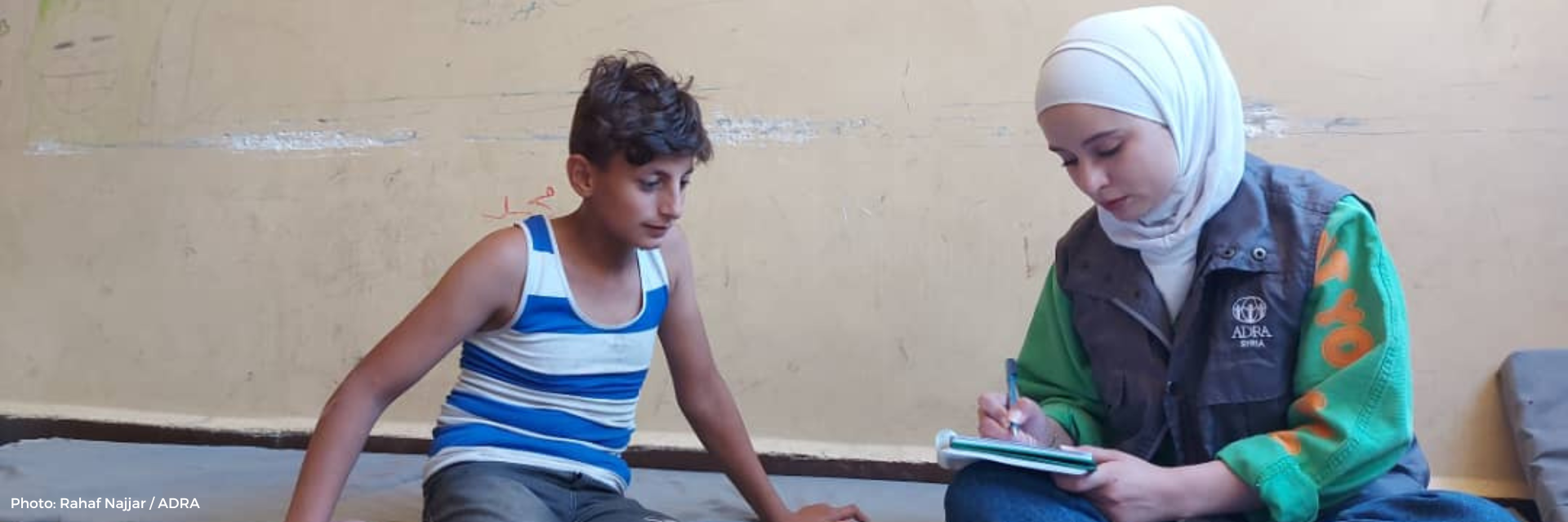 Adel with an aid worker