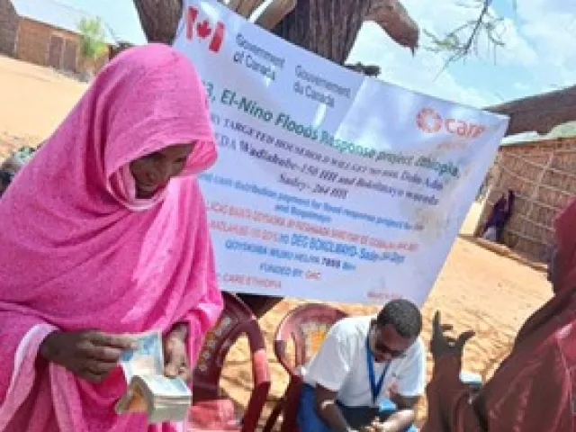 Batula receiving the cash assistance