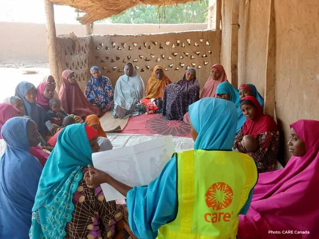 Fatima attending a nutrition session moderated by a CARE worker.