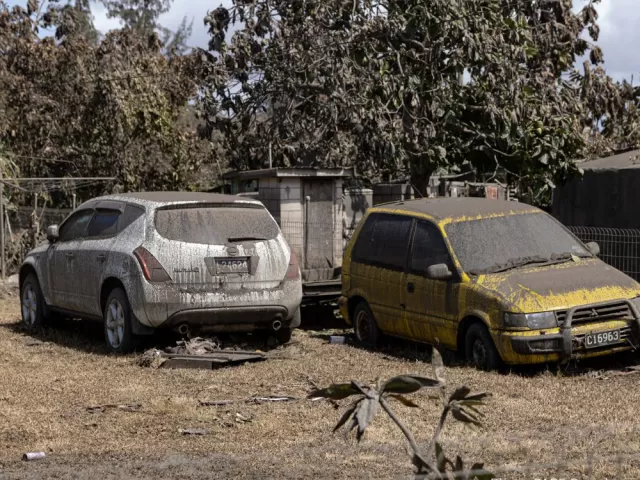 Two cars covered with ash
