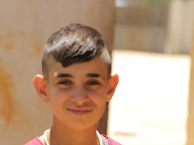 Teenage boy with smile looks at camera