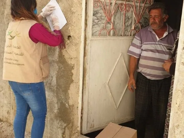 Ahmed speaks to an aid worker