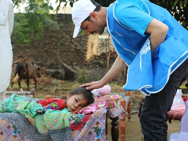 An injured child lies outside