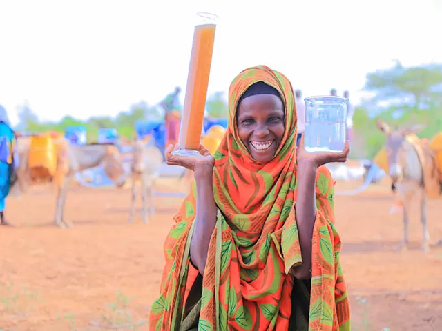 woman in Ethiopia holding clean filtered water