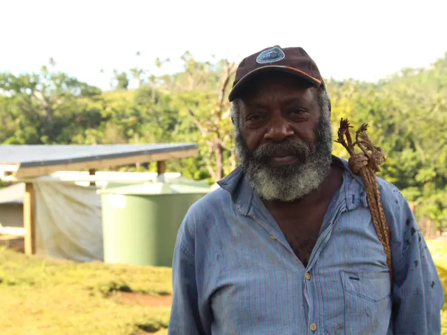 Man standing near a water tank