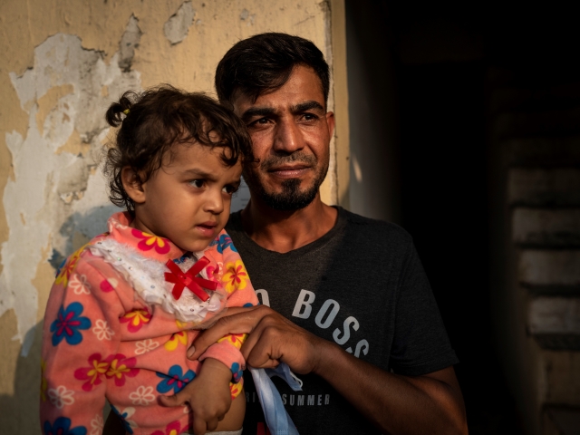 Amal's husband Mohammad with their young daughter