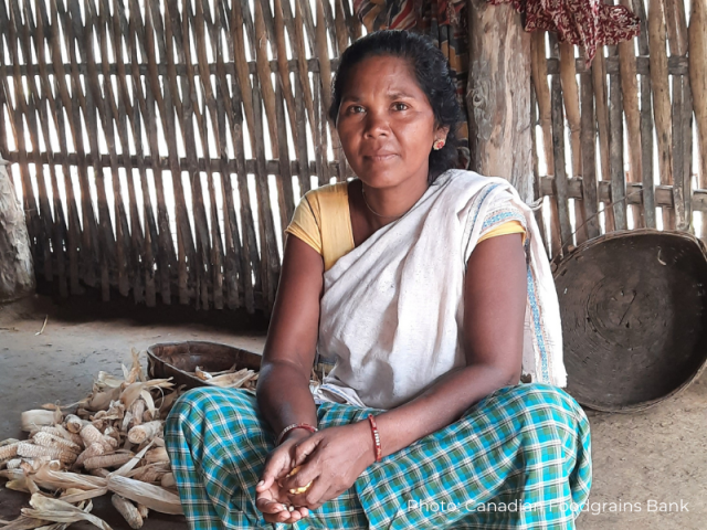 Bamdi sits cross-legged on the floor