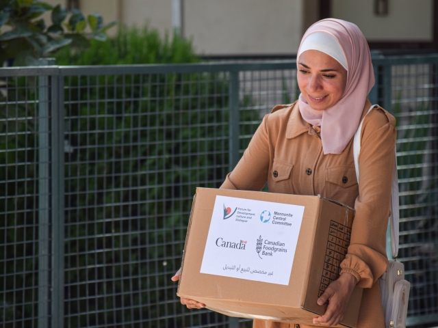 Basima carrying a package