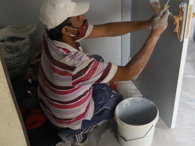 Man painting a door.