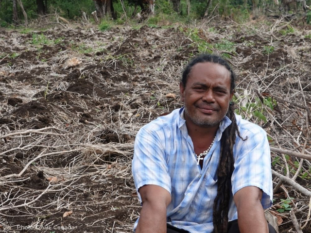 Maile is sitting among his crop of yams