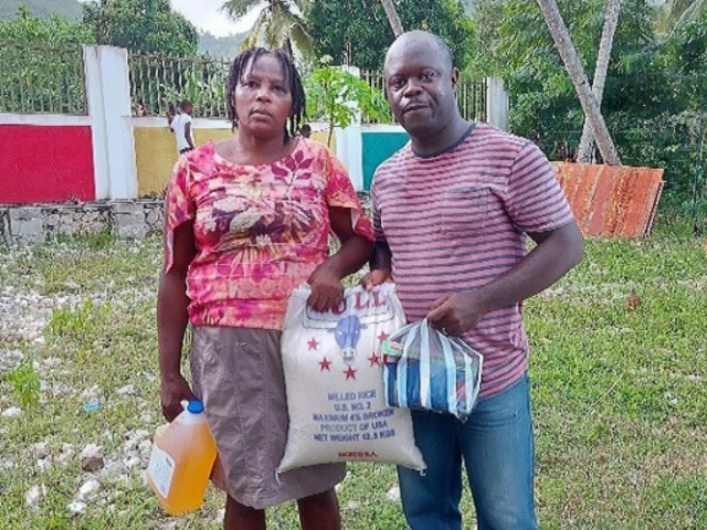 Woman and man carrying goods 