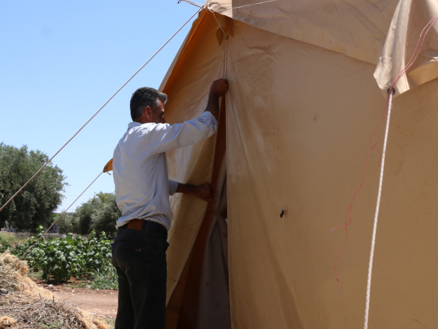 Omar in front of his tent