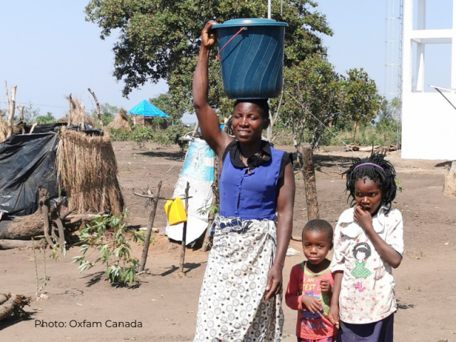 Rosa and two of her children return home with a bucket of water