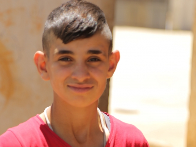 Teenage boy with smile looks at camera