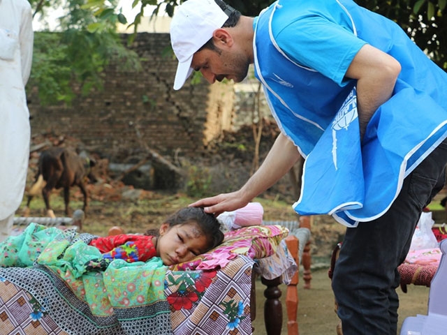 An injured child lies outside