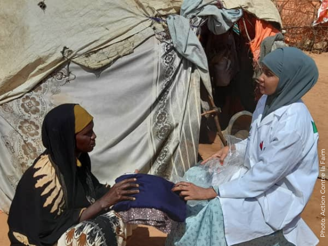 A young woman receives supplies for her family