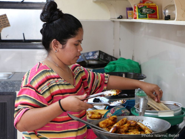 Young woman prepares food