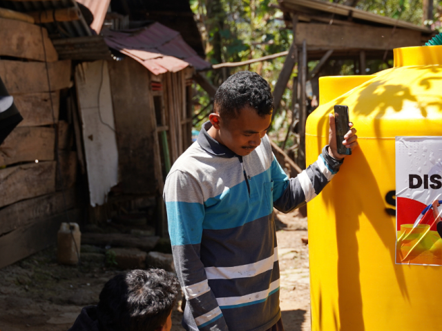 Humanitarian workers installing a water tank