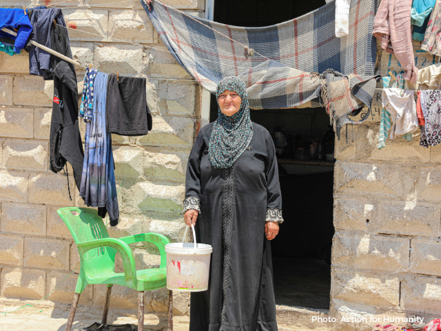 Headshot of Samah in front of her house in Syria