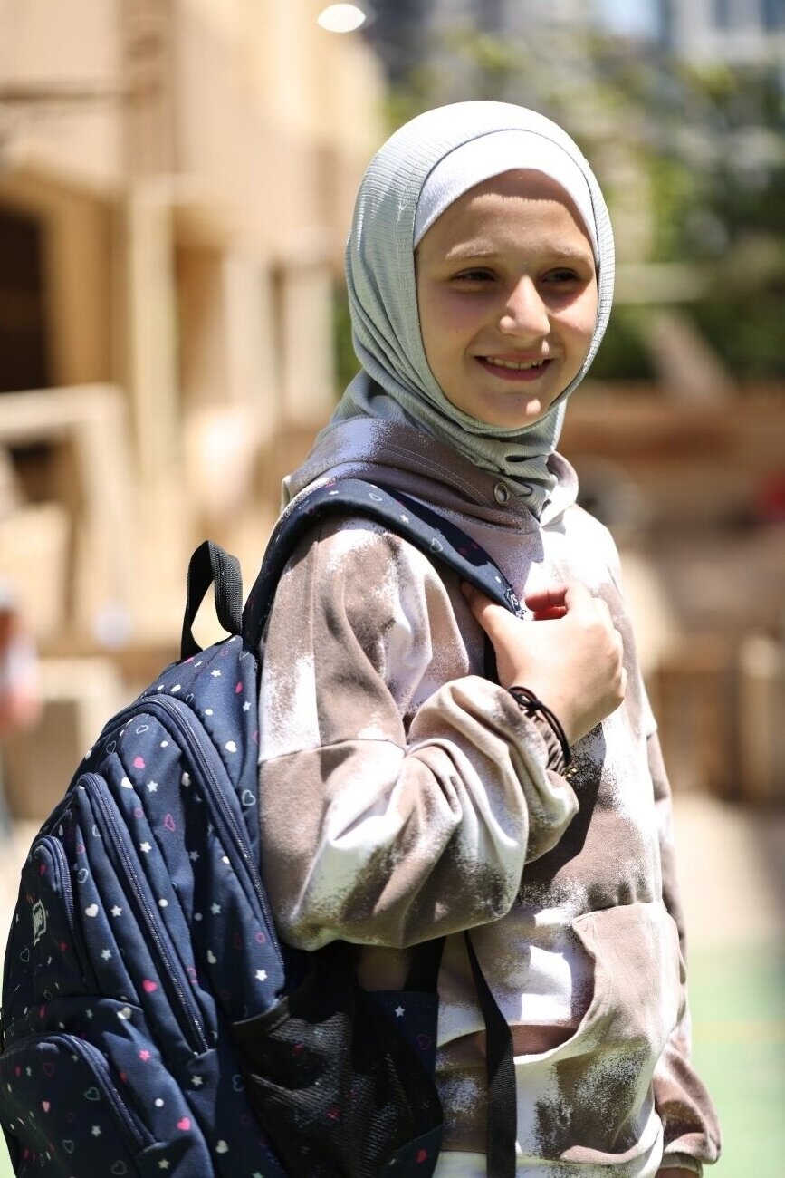 Leen* was forced to leave her home on March 2nd as conflict escalated in southern Lebanon. She was able to bring her backpack and a treasured Barbie with her to the collective shelter she lives in now.